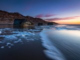 Solnedgang ved stranden i Kandestederne